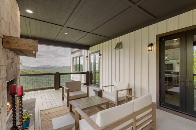 494 E Ridge Rd, Cashiers, NC 28717 - wooden deck with french doors, an outdoor hangout area, and a mountain view