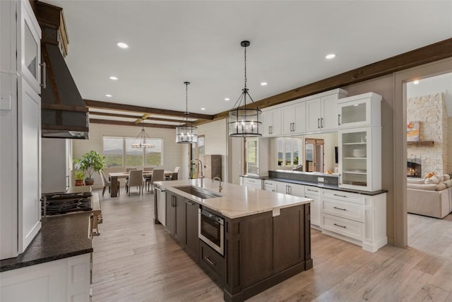 494 E Ridge Rd, Cashiers, NC 28717 - kitchen featuring a sink, built in microwave, white cabinets, recessed lighting, and glass insert cabinets