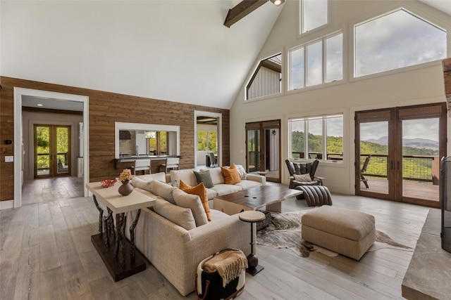 494 E Ridge Rd, Cashiers, NC 28717 - living area with french doors, high vaulted ceiling, wood walls, and hardwood / wood-style floors