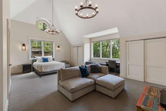 494 E Ridge Rd, Cashiers, NC 28717 - carpeted bedroom featuring a chandelier, high vaulted ceiling, multiple closets, and multiple windows