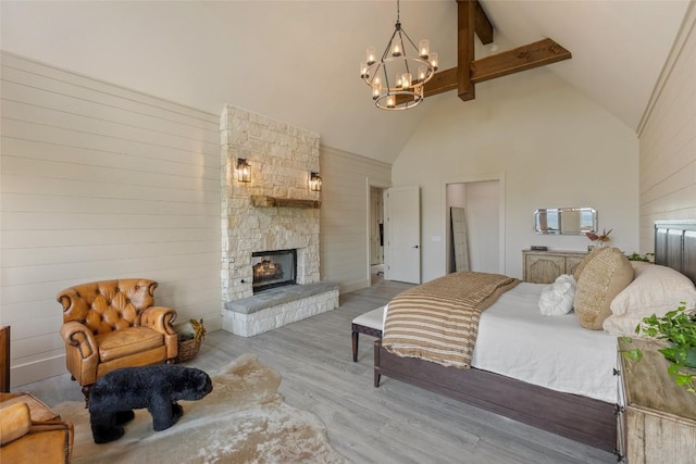 494 E Ridge Rd, Cashiers, NC 28717 - bedroom with high vaulted ceiling, a chandelier, beamed ceiling, wood finished floors, and a fireplace