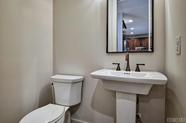 bathroom featuring sink and toilet