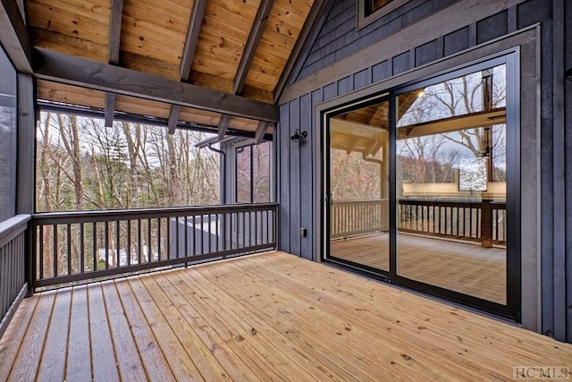 unfurnished sunroom with lofted ceiling with beams and wood ceiling