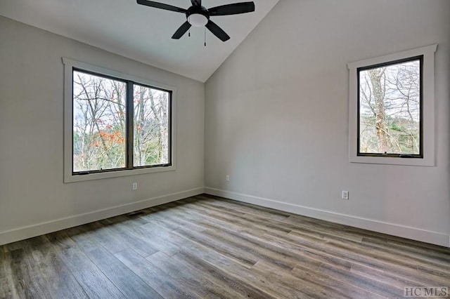 empty room featuring hardwood / wood-style floors, high vaulted ceiling, and ceiling fan