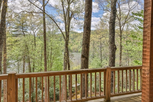 wooden deck with a wooded view