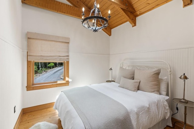bedroom with wooden ceiling, a chandelier, wood finished floors, beam ceiling, and high vaulted ceiling