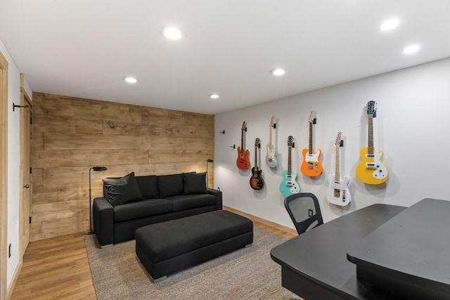 living area featuring wood finished floors, recessed lighting, and wood walls