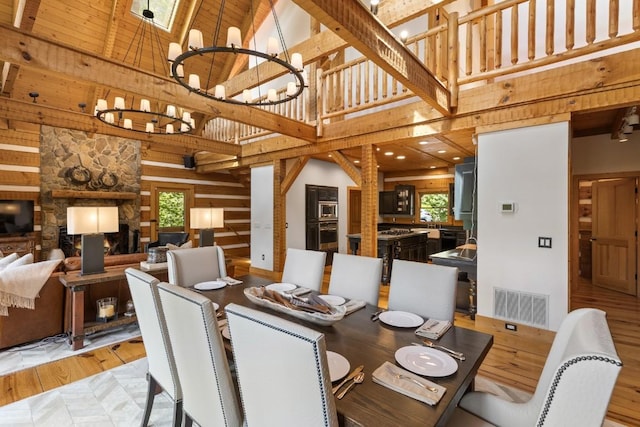 268 Tocami Trl, Cullowhee, NC 28723 - dining space with high vaulted ceiling, a chandelier, light wood-style floors, and wooden walls