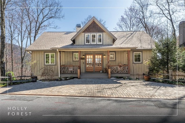 83 Flyaway Cir, Sapphire, NC 28774 - view of front of property with covered porch, roof with shingles, french doors, a chimney, and board and batten siding
