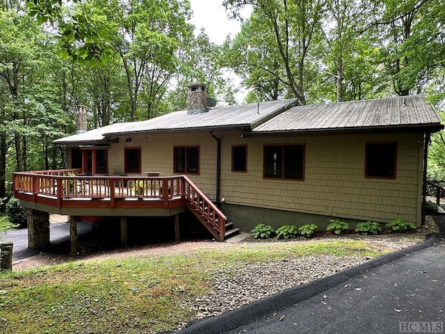 back of property with a wooden deck