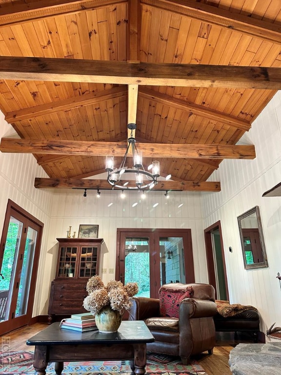 living room featuring a healthy amount of sunlight, wood ceiling, and a chandelier