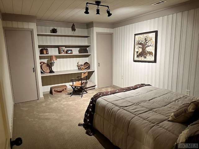 bedroom with wooden ceiling and carpet flooring