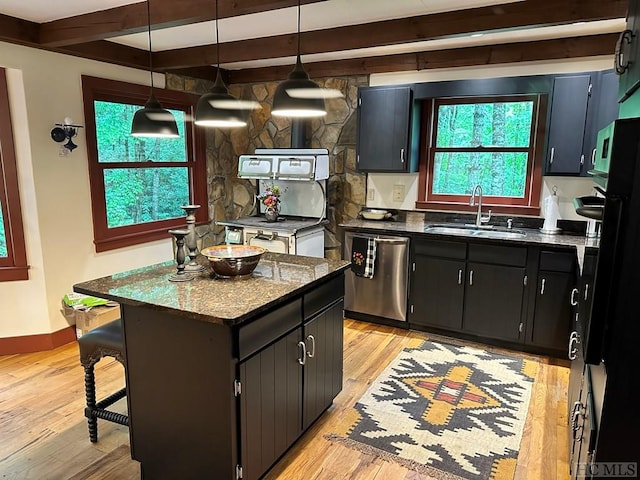 kitchen featuring sink, light wood-type flooring, dishwasher, and a kitchen island