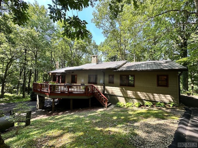 rear view of house featuring a wooden deck