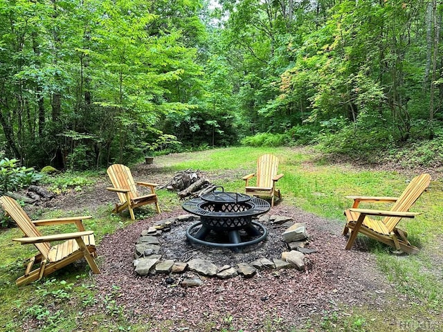 view of yard with a fire pit