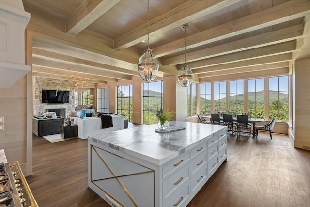 893 High Mountain Dr, Cashiers, NC 28717 - kitchen with a stone fireplace, white cabinetry, dark wood finished floors, hanging light fixtures, and wood ceiling with exposed beams