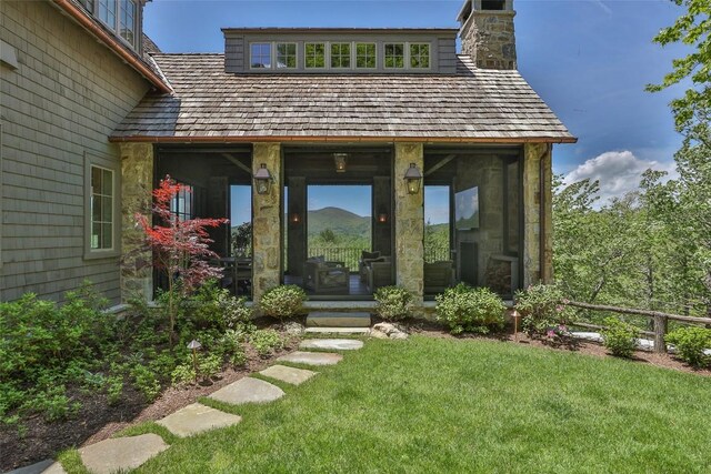 893 High Mountain Dr, Cashiers, NC 28717 - view of exterior entry featuring stone siding and a chimney