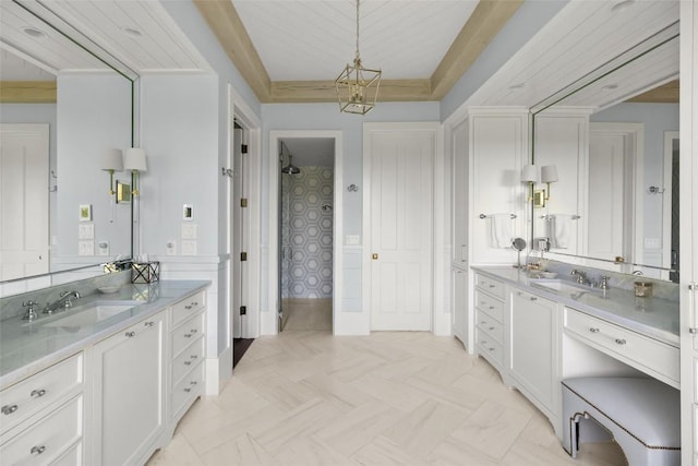 893 High Mountain Dr, Cashiers, NC 28717 - bathroom with two vanities, a raised ceiling, and baseboards
