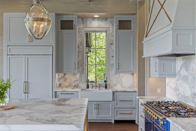 893 High Mountain Dr, Cashiers, NC 28717 - kitchen featuring premium range hood, range, light stone counters, and plenty of natural light