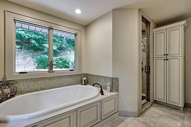 bathroom with tile patterned floors and independent shower and bath