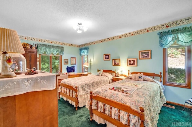 carpeted bedroom with a textured ceiling