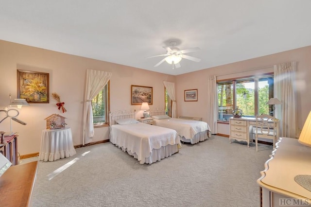 bedroom featuring ceiling fan and carpet