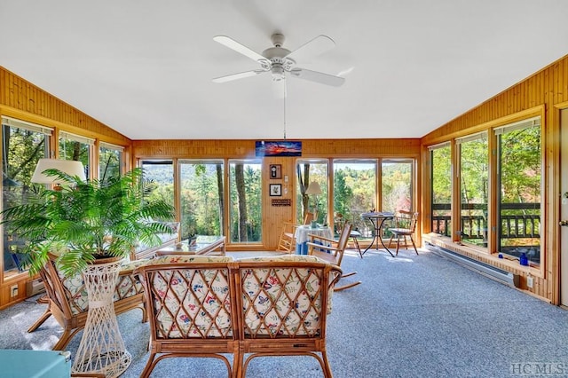 sunroom featuring vaulted ceiling, ceiling fan, and baseboard heating