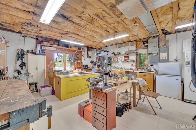 kitchen featuring a center island, refrigerator, and butcher block countertops