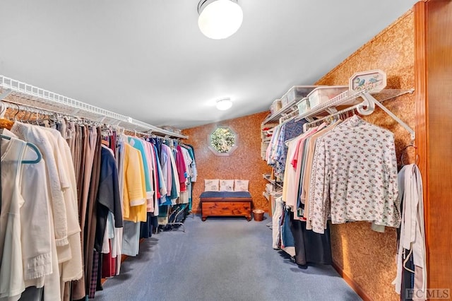 walk in closet featuring dark colored carpet