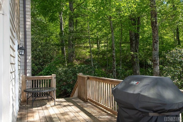 wooden terrace featuring a grill