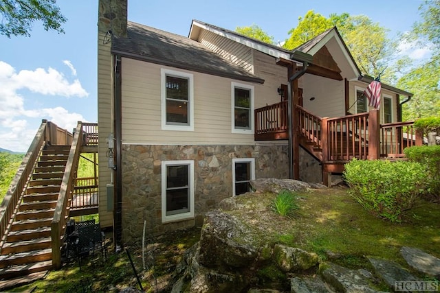 back of property featuring a wooden deck