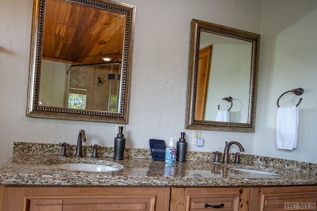 bathroom with wooden ceiling, vanity, and walk in shower