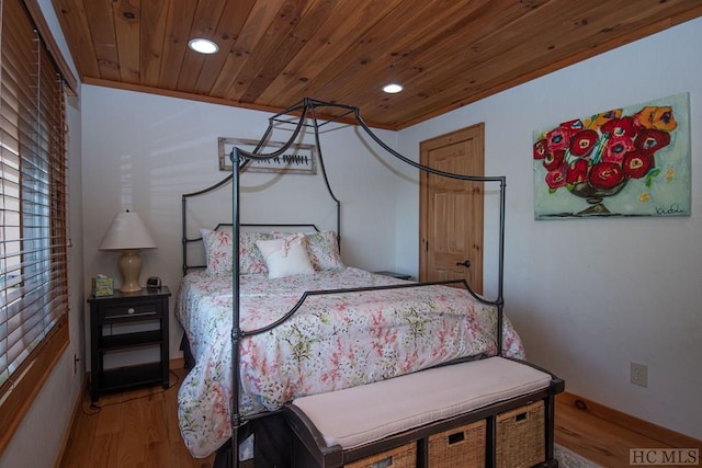 bedroom with light hardwood / wood-style floors and wood ceiling