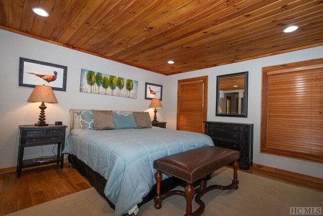 bedroom with wooden ceiling and light hardwood / wood-style flooring