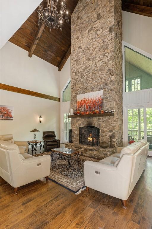 115 Falls Ct W, Highlands, NC 28741 - living room with high vaulted ceiling, wood finished floors, a chandelier, a wood ceiling with exposed beams, and a fireplace