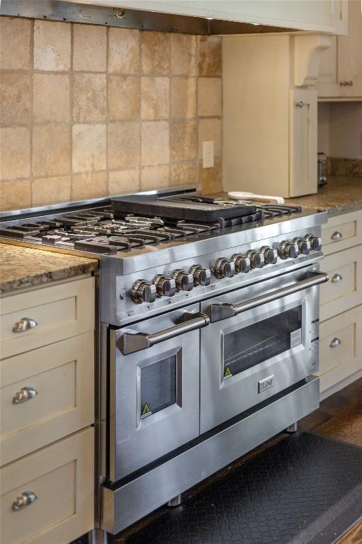 115 Falls Ct W, Highlands, NC 28741 - kitchen featuring double oven range, backsplash, white cabinets, dark wood finished floors, and light stone counters