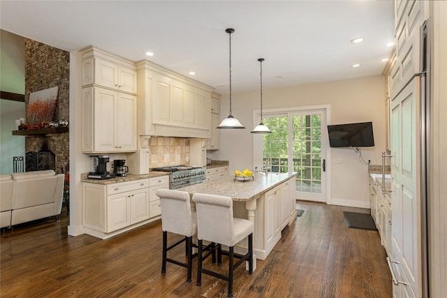 115 Falls Ct W, Highlands, NC 28741 - kitchen with dark wood-style flooring, range with two ovens, decorative backsplash, light stone countertops, and recessed lighting