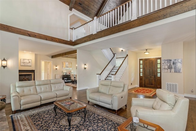 115 Falls Ct W, Highlands, NC 28741 - living area featuring wood finished floors, beamed ceiling, high vaulted ceiling, stairway, and a fireplace