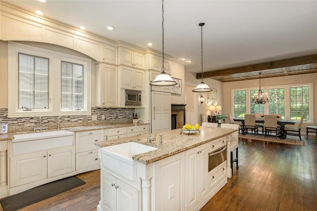 115 Falls Ct W, Highlands, NC 28741 - kitchen with a warming drawer, dark wood-type flooring, stainless steel microwave, beam ceiling, and decorative backsplash