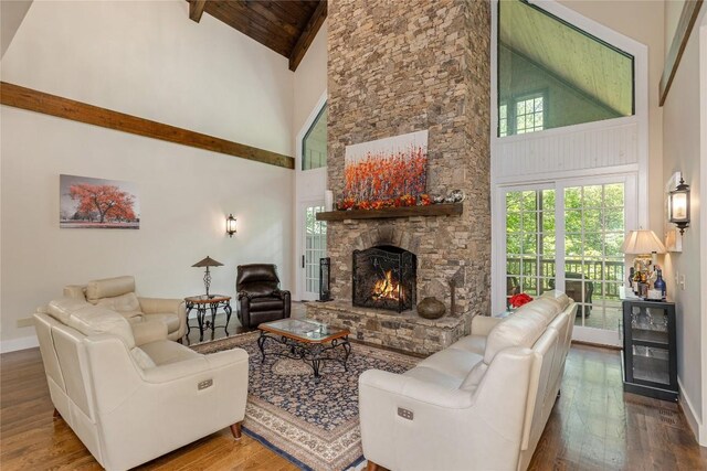 115 Falls Ct W, Highlands, NC 28741 - living area with high vaulted ceiling, hardwood / wood-style flooring, a stone fireplace, and a wood ceiling with exposed beams