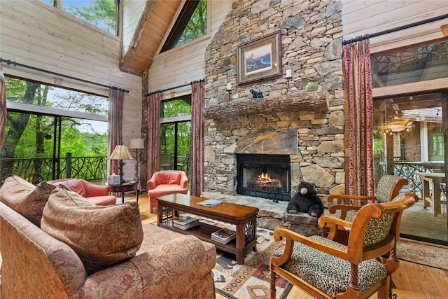 sunroom with a stone fireplace and vaulted ceiling