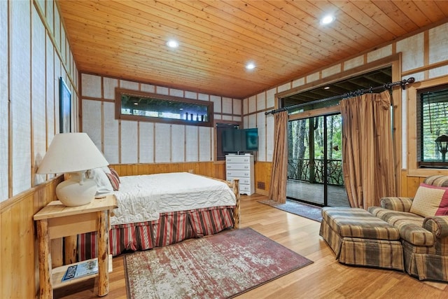 bedroom featuring wood ceiling, wood walls, light wood-type flooring, and access to outside