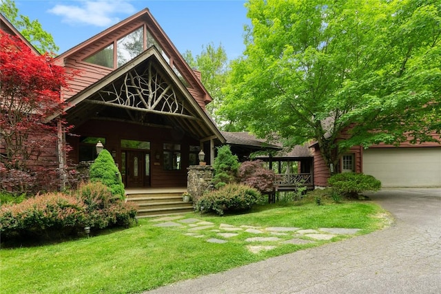 view of front facade with a garage and a front lawn