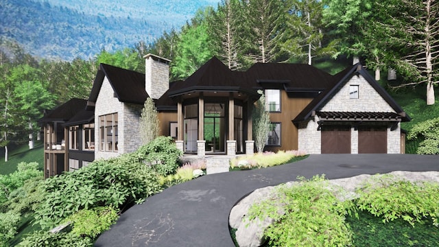 view of front of home featuring aphalt driveway, stone siding, a garage, and a chimney