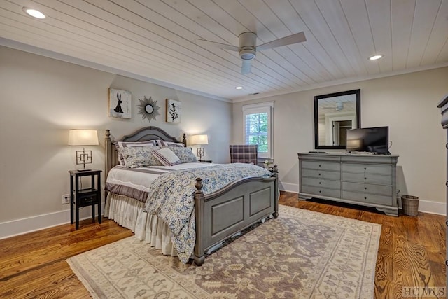 bedroom with ceiling fan, wood ceiling, ornamental molding, and hardwood / wood-style flooring