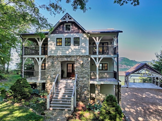 view of front of home with a carport and a balcony