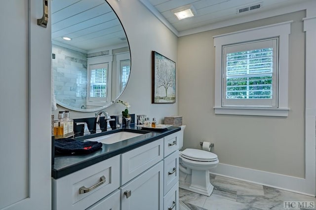 bathroom featuring toilet, vanity, and ornamental molding