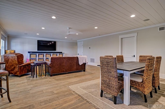 dining room with light wood-type flooring, crown molding, and wooden ceiling