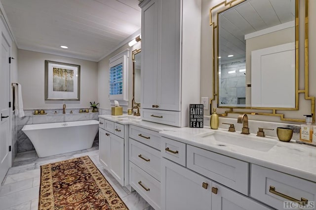 bathroom featuring vanity and a washtub