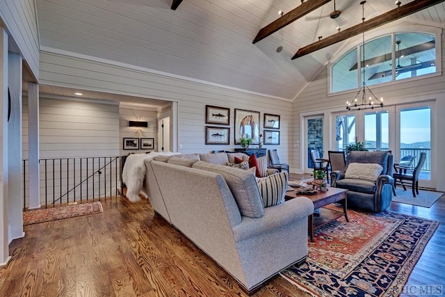 living room featuring hardwood / wood-style floors, an inviting chandelier, wood walls, high vaulted ceiling, and beam ceiling